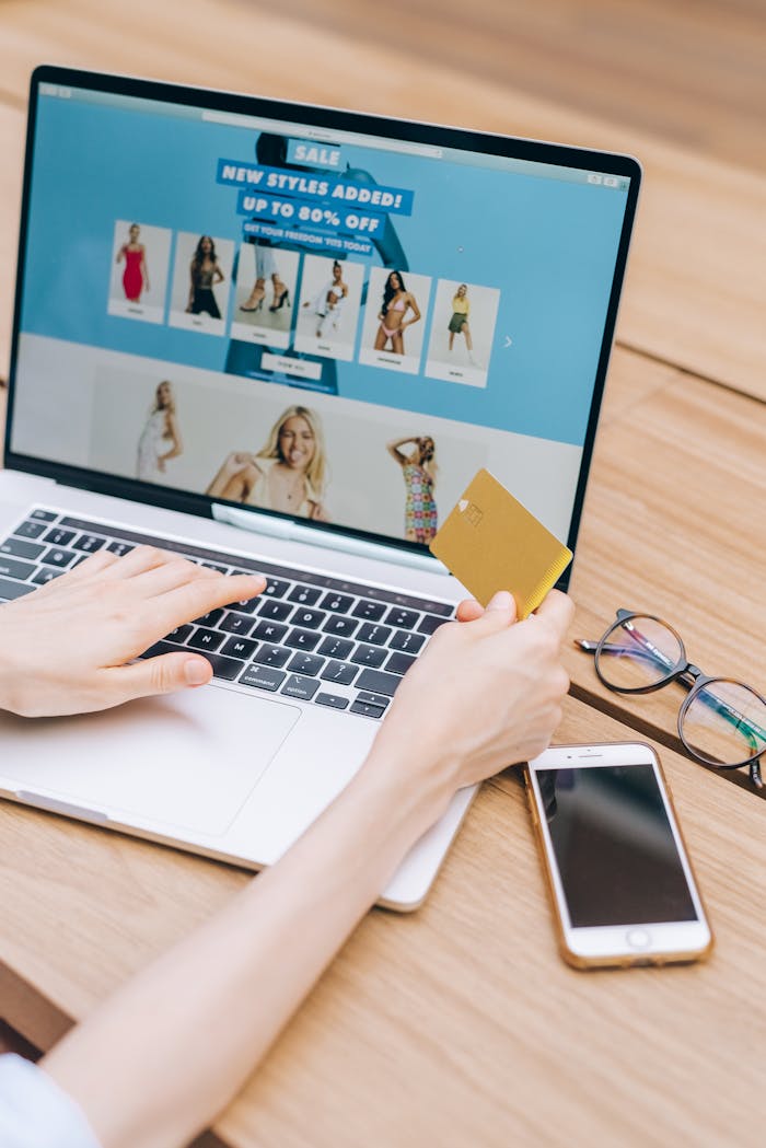 Person shopping online using a laptop and credit card, lifestyle technology concept.